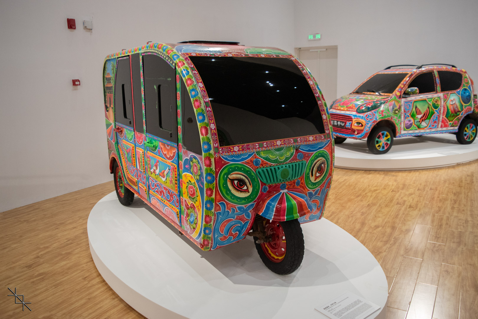 Small car decorated with truck art.